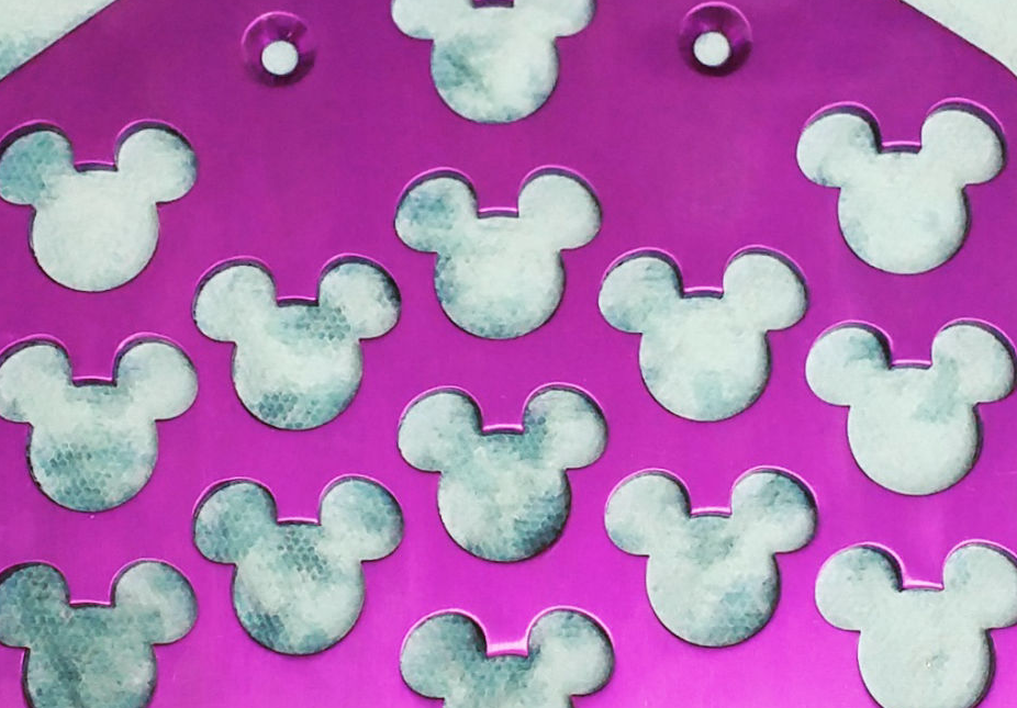 image of wheelchair foot plate with mickey mouse pattern cut into it